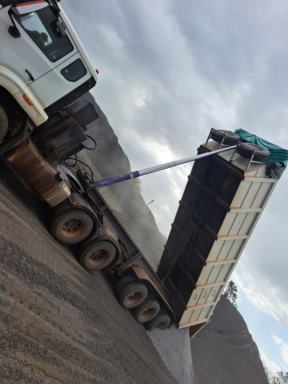 Tipper raising its body to offload ballast at site